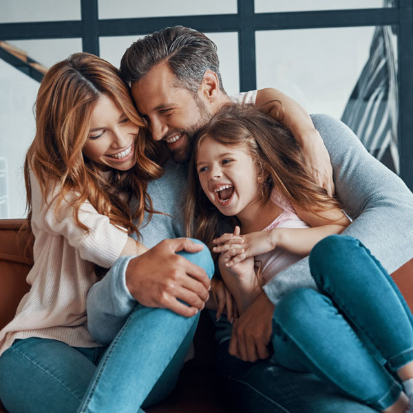 laughing family of three