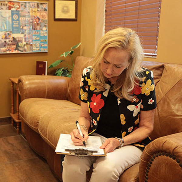 woman filling out paperwork